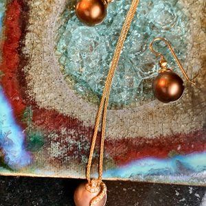 Yvel brown pearl and diamond pendant with matching earrings.